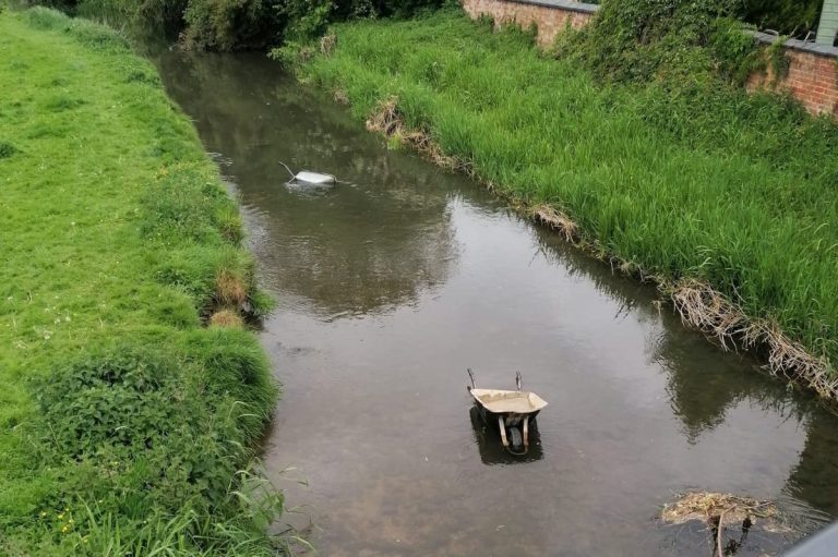 Two wheelbarrows in the river behind the Woolpack